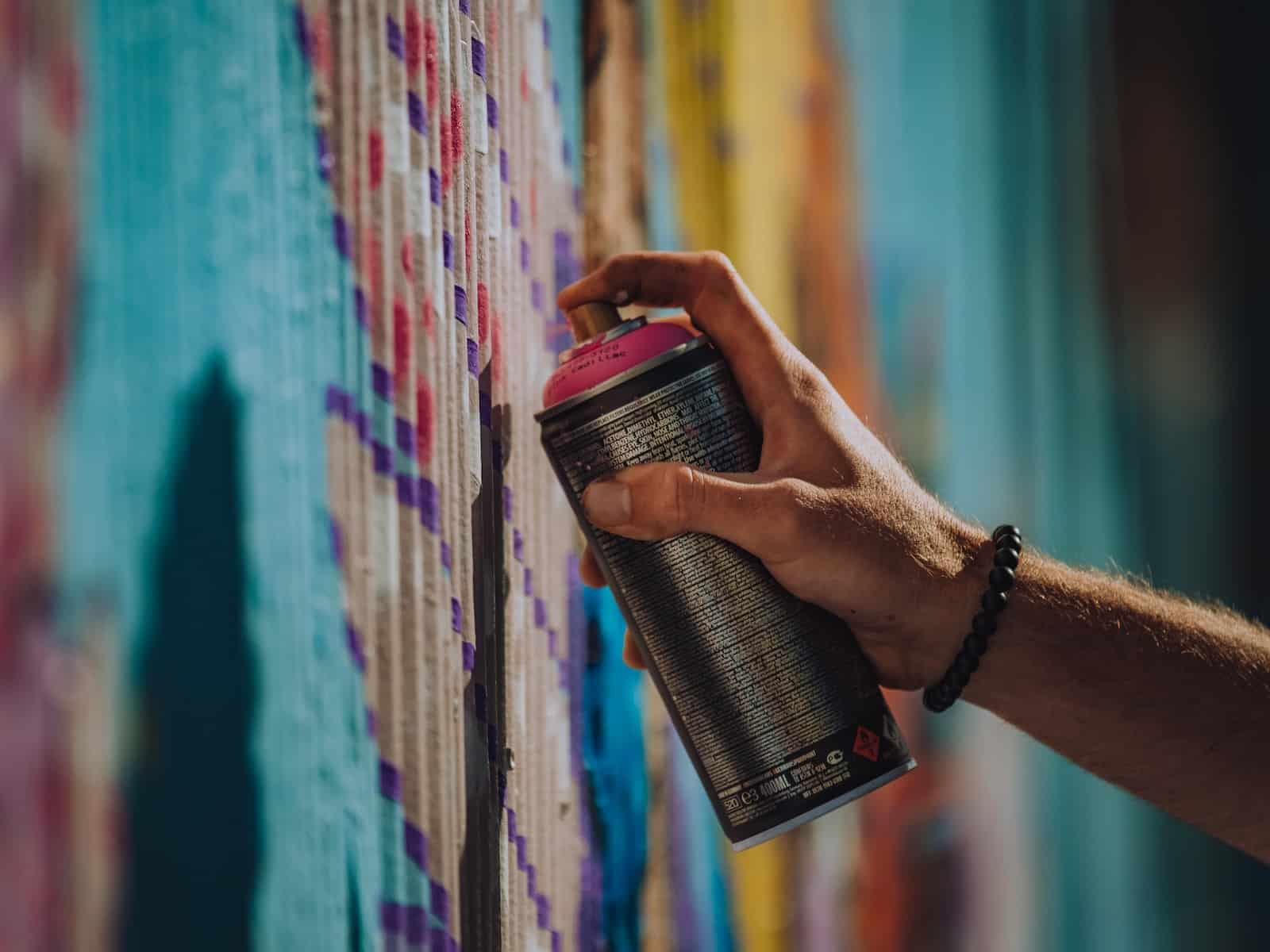 person holding black and red can