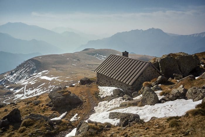 a small building sitting on the side of a mountain