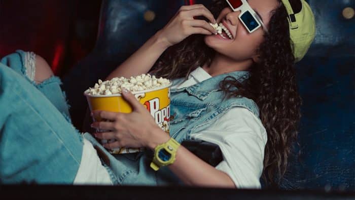 🎬 Soirée Cinéma – Le Meilleur du Court Métrage à Grenoble ! 79 a woman sitting in a chair eating popcorn and watching a movie